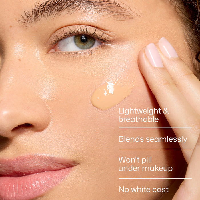 Close-up of a woman's face with a hand applying a cosmetic product, highlighting features like 'lightweight & breathable', 'blends seamlessly', 'won't pill under makeup', and 'no white cast'.