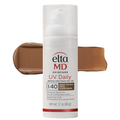 Elta MD UV Daily sunscreen bottle with a brown swatch on a white background