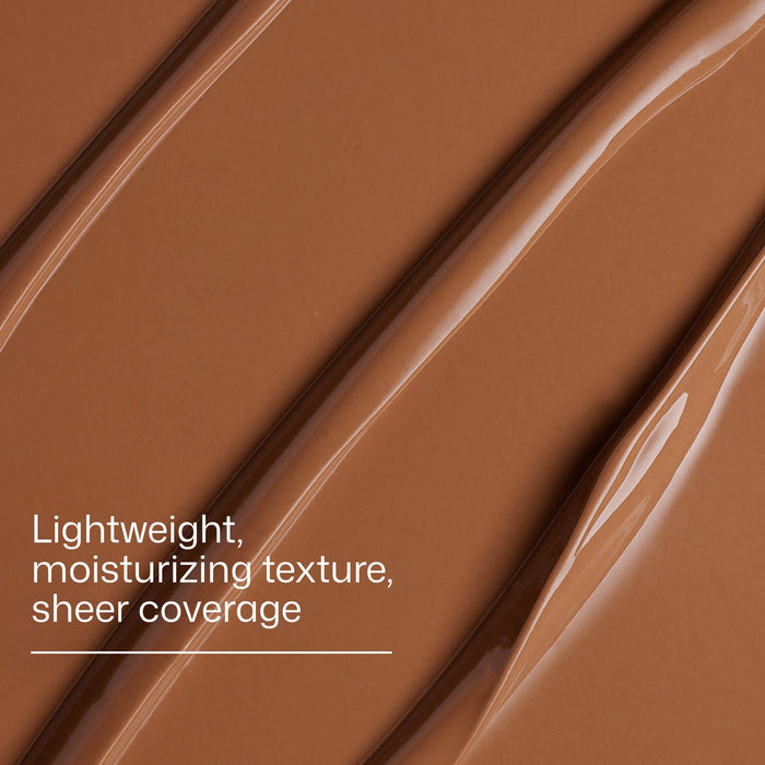 Close-up of brown makeup product with text describing texture and coverage