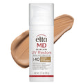 Elta MD UV Restore sunscreen bottle with a swatch of tan color on a white background
